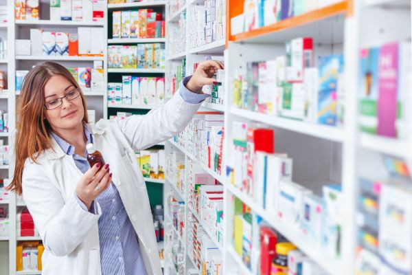 Pharmacist checking medicine at store