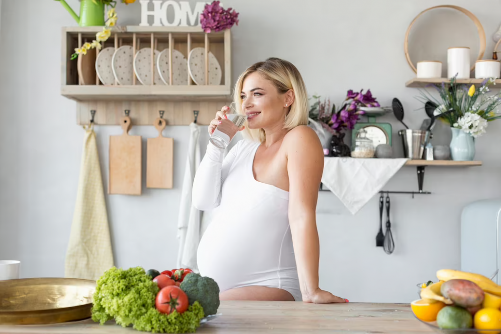 Side view pregnant woman drinking water